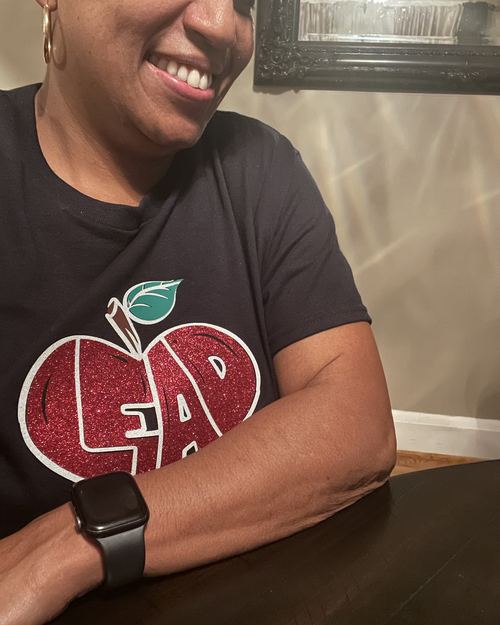 Educator wearing LEAD with Heart shirt